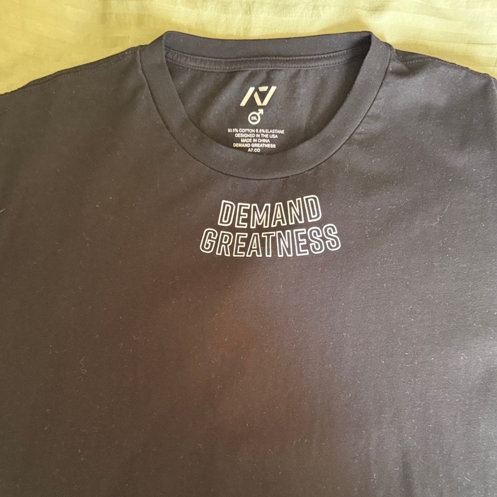 A7- Black with white text ‘Demand Greatness’ Meet T-Shirt